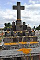 Gravestone in shape of tzompantli (Aztec skull rack) in the church cemetery