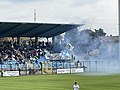Ultras della Giana Erminio durante una partita casalinga nel 2023: si notano gli striscioni e le bandiere Irriducibili e Quei bravi ragazzi