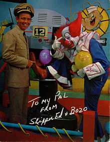 A publicity photo of Skipper Ed, a man in a captain's outfit, and Bozo the Clown, a clown, with a W F G A-TV camera. The photo is signed: "To My Pal from Skipper Ed and Bozo".
