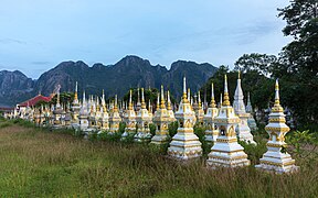 White and golden graves in a Buddhist cemetery at sunrise in Vang Vieng