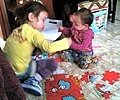 Image 18Girls assembling a puzzle (from Girls' toys and games)