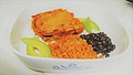 Chicken enchiladas with red sauce, red rice, black beans, and avocado