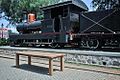 old 0-6-0 locomotive next to the Lawang Sewu building