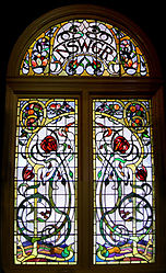 One of a series of large windows of Art Nouveau design in Favrile and cathedral glass, with the state's floral emblem, the waratah, Sydney Central Station, NSW, Australia. Despite the complexity, the execution was classed as "leadlighting".