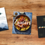 Three books on a wooden table background