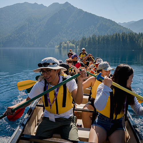 Students canoeing a mountain lake