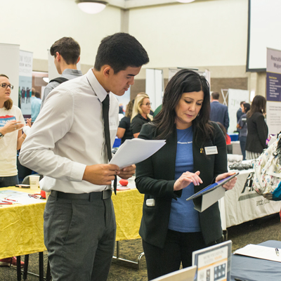 Student talking with a potential employer at a job fair