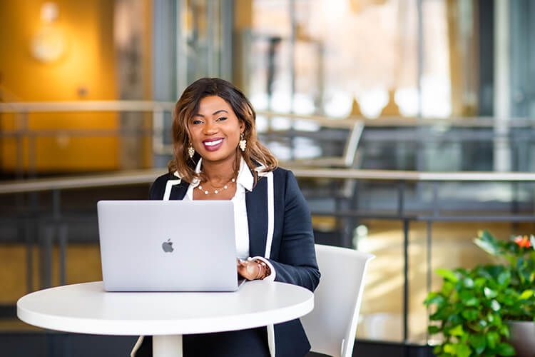 Woman sitting at a table with a laptop