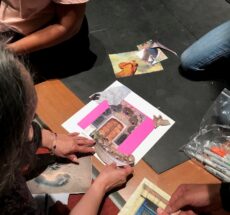 hands working together on an art collage.