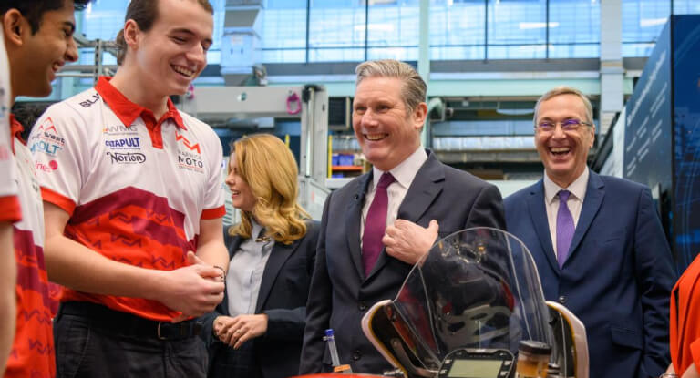 Labour leader Kier Starmer smilling with Vice-Chancellor Stewart Croft and several WMG students