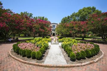 Photo of Swem Library in the spring with the sundial in the foreground 