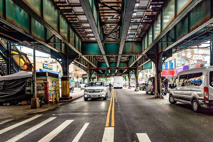 The Grand Concourse Avenue street in the Bronx borough, underneath subway tracks.