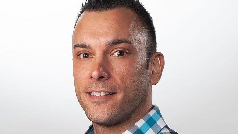 A headshot of a person against a white background