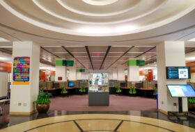 Large open area of the Swem Library foyer with displays, computer stations and wayfinding screens.