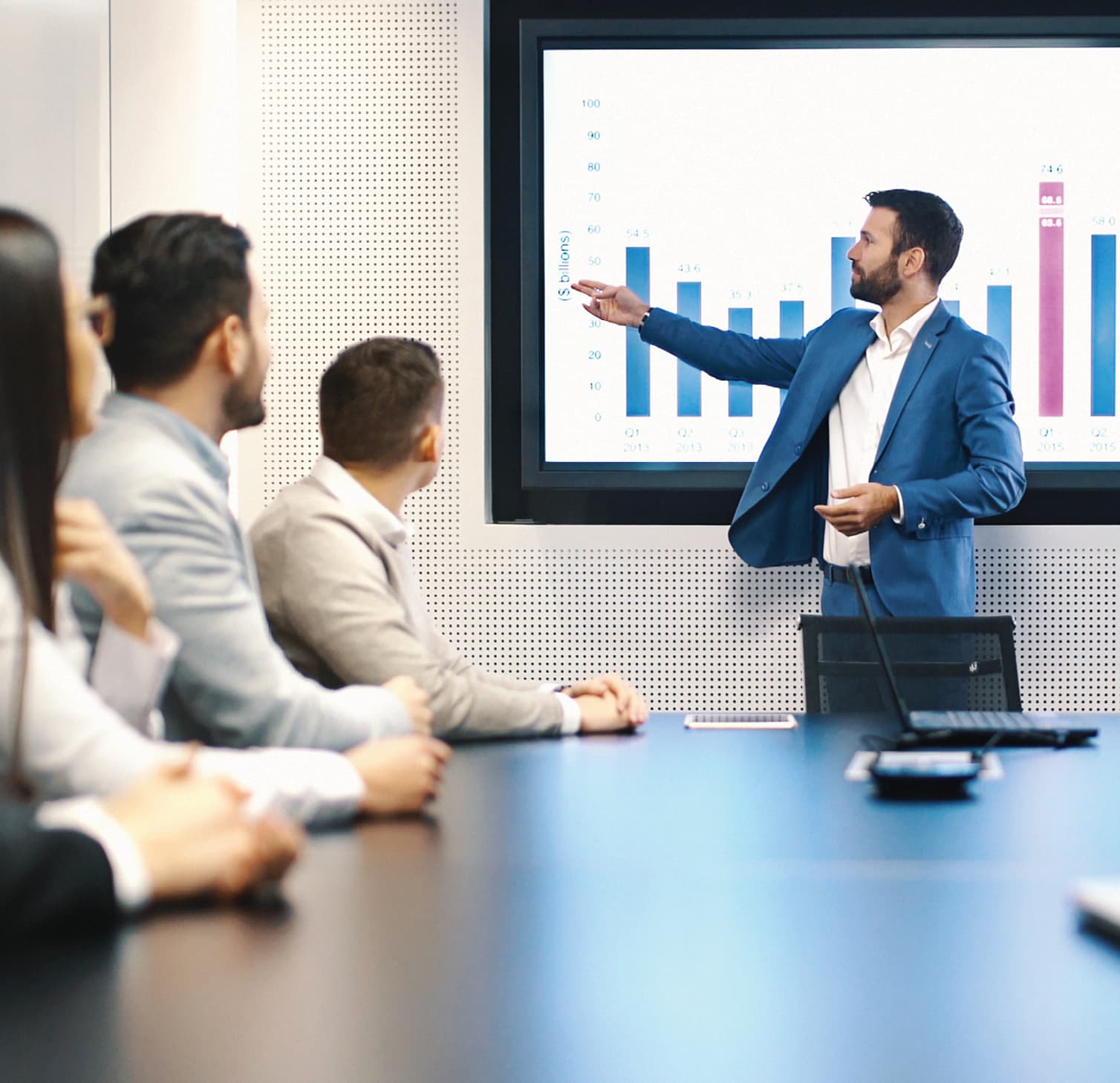 Man standing in front of a screen leading a meeting