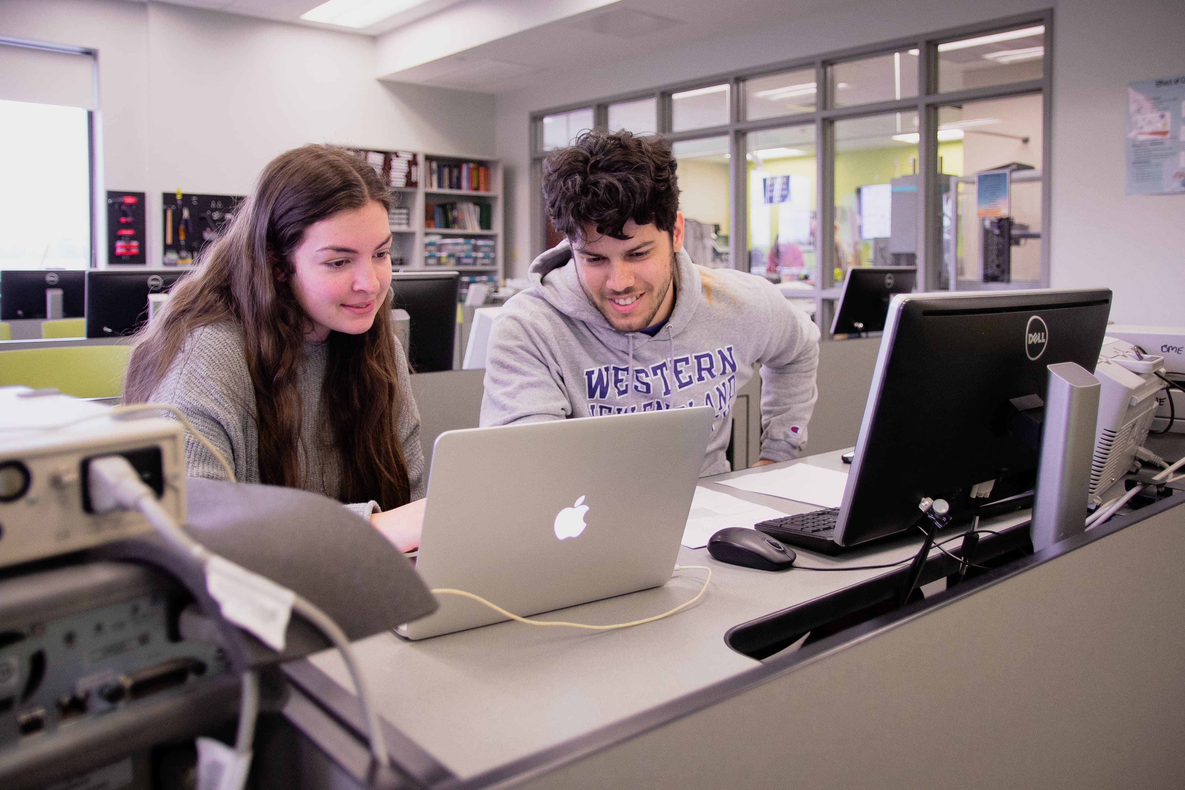 Two students working together at computer in a lab