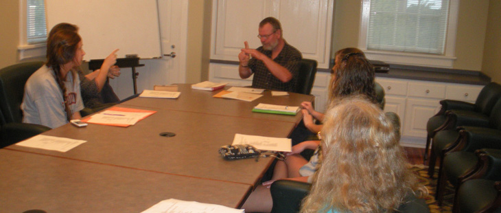 Members of community course hold a meeting