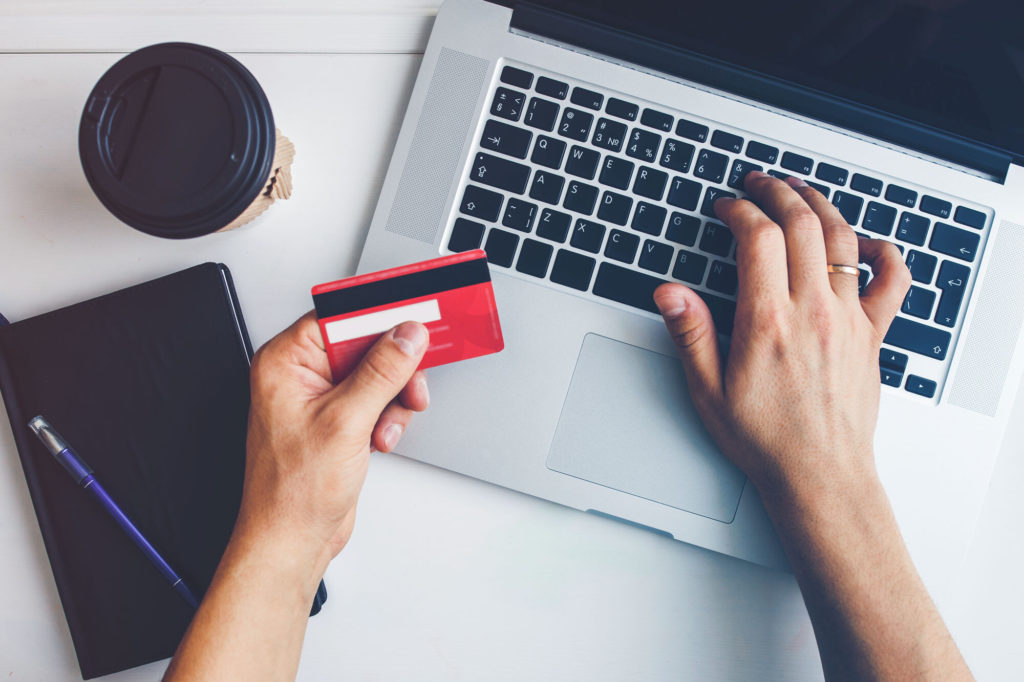 hand holding card while online shopping