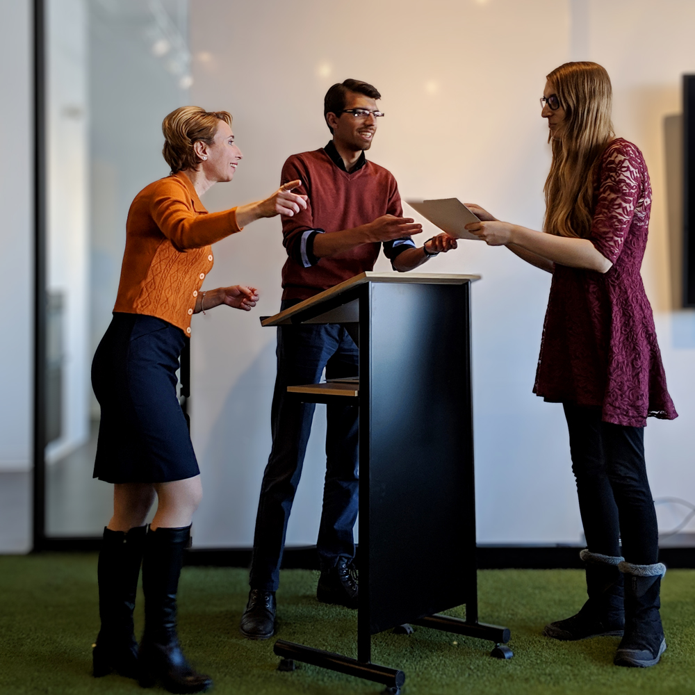 Eirene Seiradaki and Chris Srinavasa presenting a certificate to a Borealis AI Fellowship candidate.