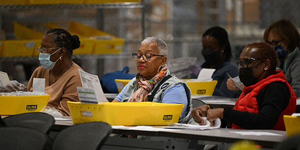 Election workers review documents. 