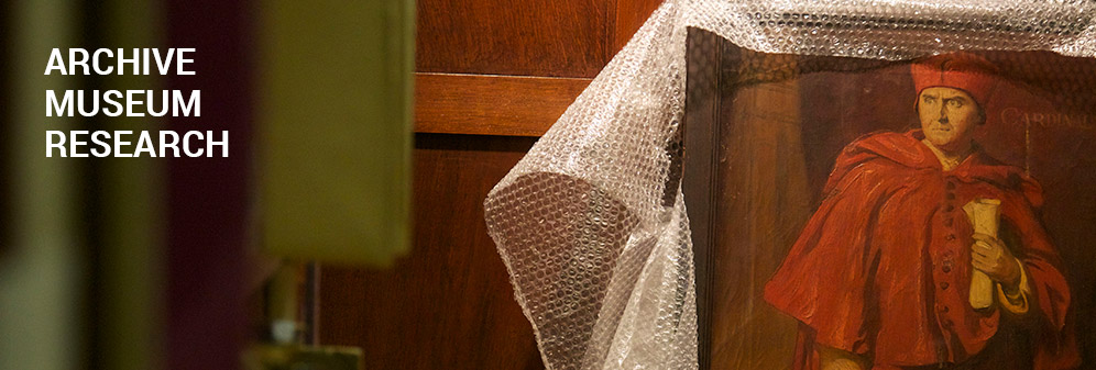 A portrait of a cardinal. The frame is partially covered with bubble wrap. The words 