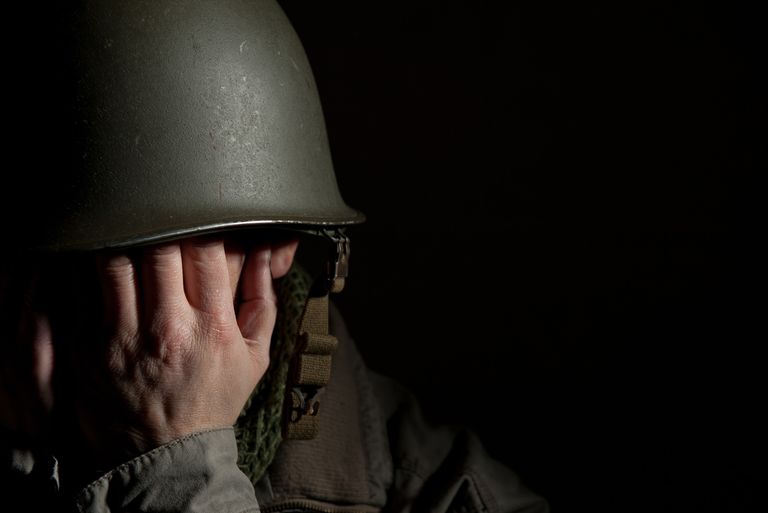 US soldier covering face with hands