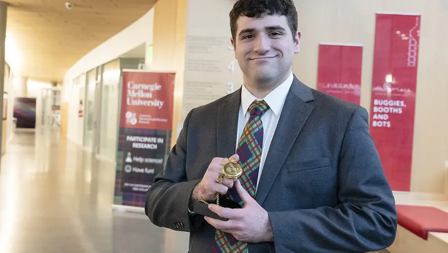 Benjamin Glaser holding award