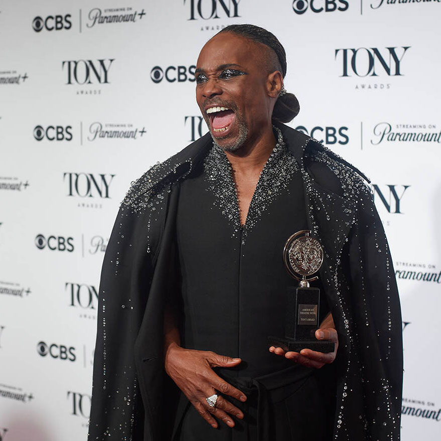 Billy Porter holding a Tony Award.