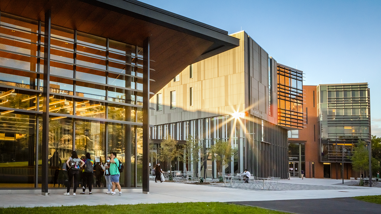 Students walking in front of two new dormitories.