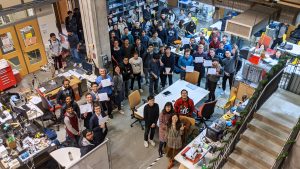 A group of students pose in the Hackerman robotorium.