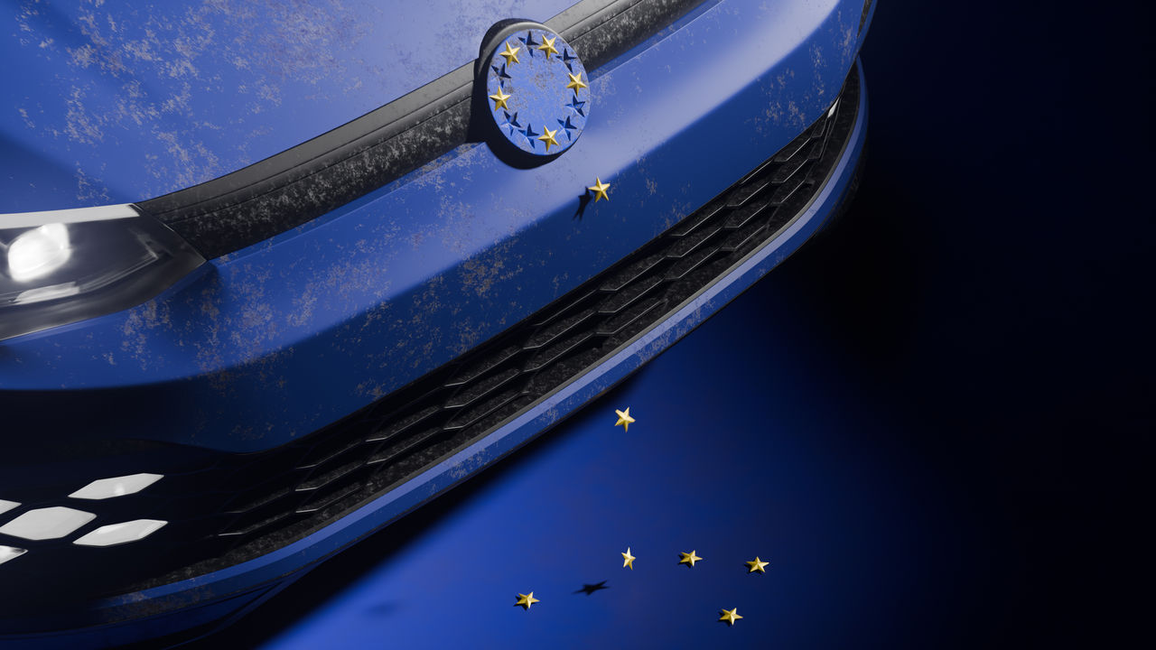 The front of a car with its logo. Instead of being a car logo, it is a representation of the European flag, with the stars falling.