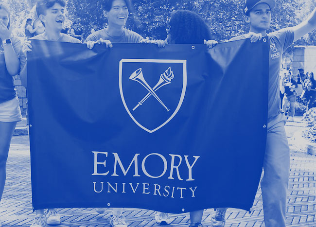 Students holding an Emory University banner in celebration