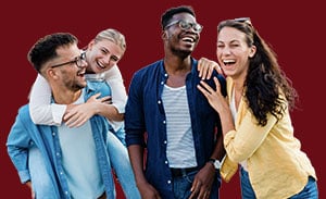 Four friends standing together and laughing.