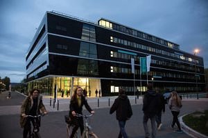 People outside the Max Planck Institute for the Science of Light at dusk.