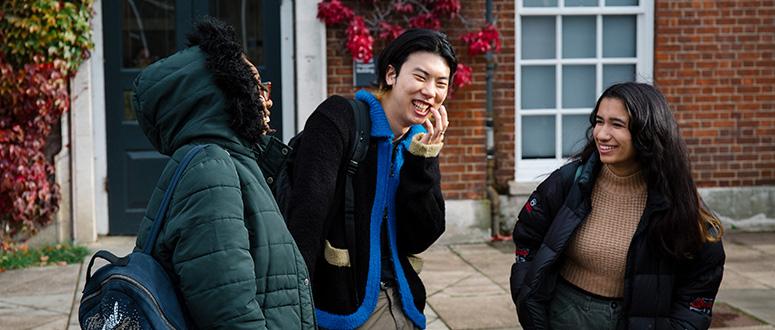 Three students talking and laughing