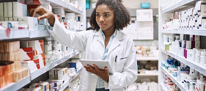 pharmacist checking stock of medicine