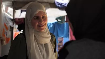 Dr. Samar al-Hajj speaks with an individual in a refugee camp