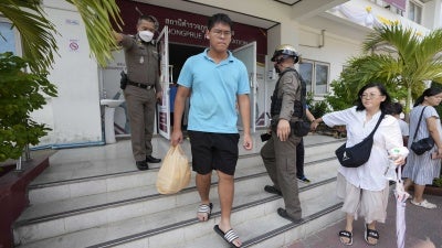 Members of the Shenzhen Holy Reformed Church, also known as the Mayflower Church, leave from the Nongprue police station on their way to Pattaya Provincial Court in Pattaya, Thailand, March 31, 2023.