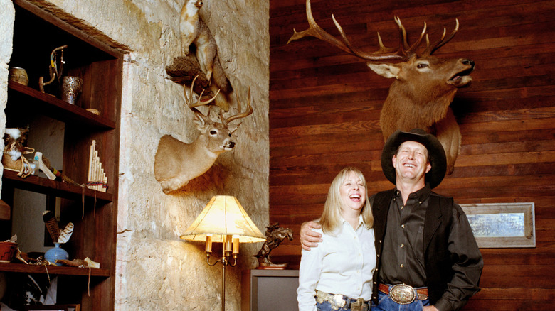 Stereotypical taxidermy setting and owners.