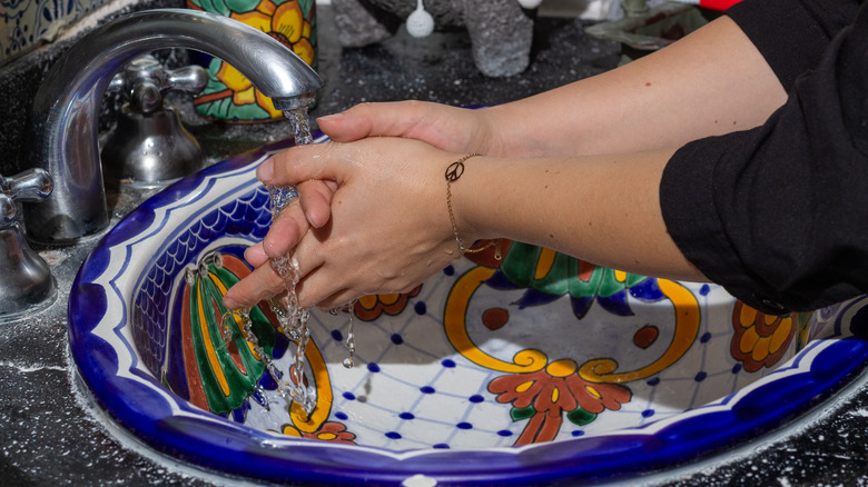 washing hands in colorful Talavera sink