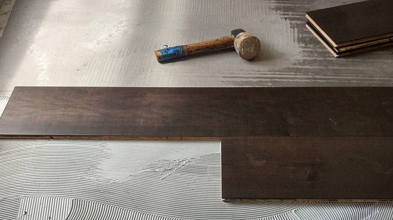 An engineered hardwood floor being installed.