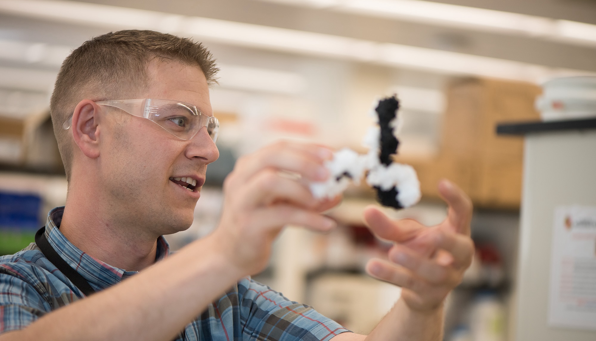 Dr. John Schiel holding a figure of the NISTmAb