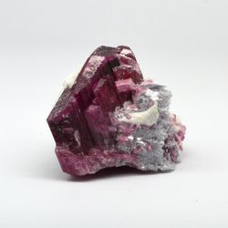 cherry tourmaline crystal in association with zeolite and lepidolite.