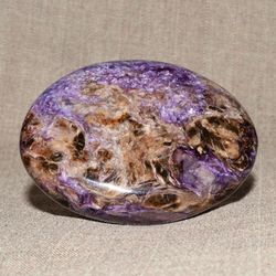 a polished pebble made of charoite