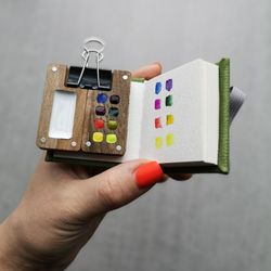 mini wooden watercolor palette (8 cells for colors), with tiny sketchbook.