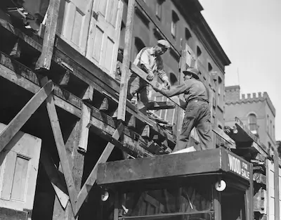 two men working on building