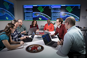 Multiple scientists working together around a single table