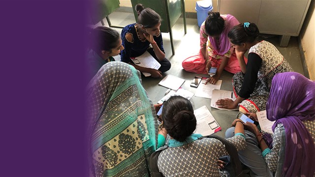 SCAI header - photo a a group of women sitting on the floor working on their phones