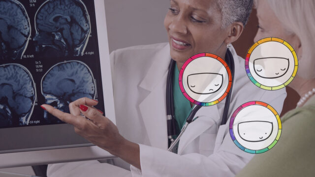 doctor showing patient her brain scan on a monitor