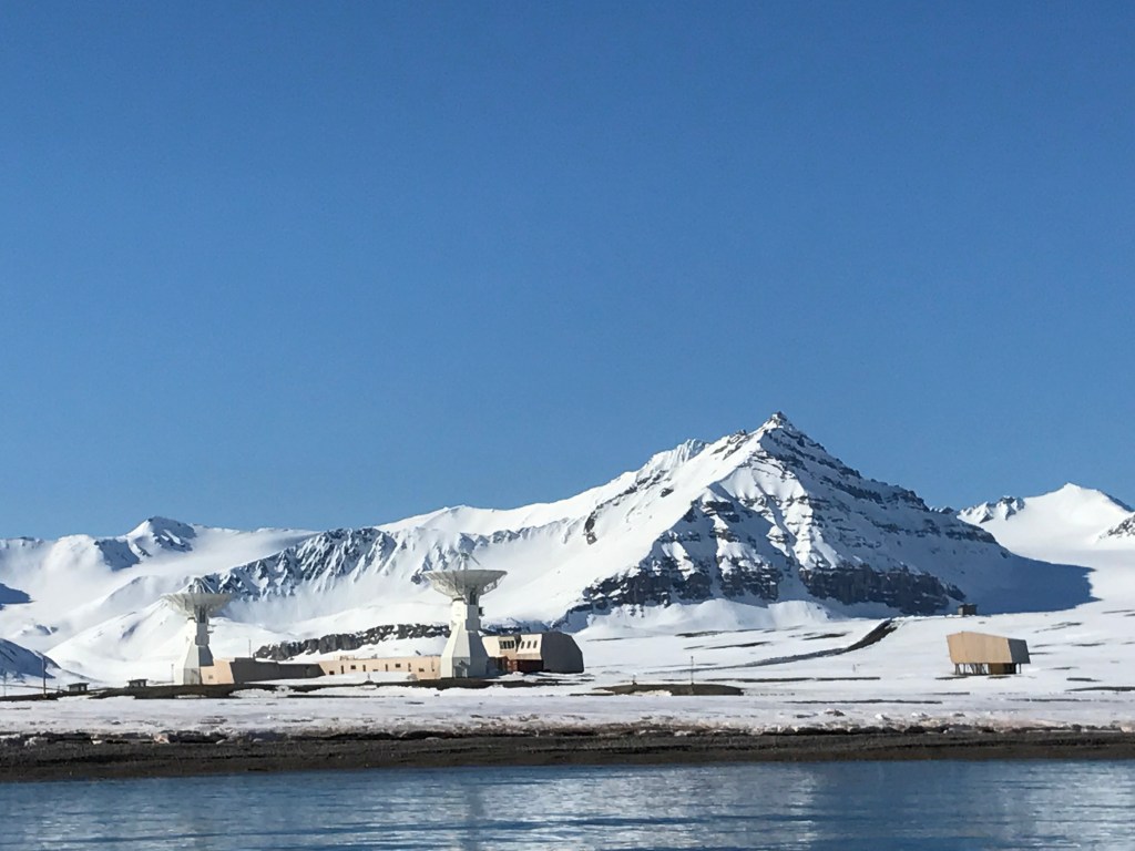 Snowy mountain backdrop behind NASA facility